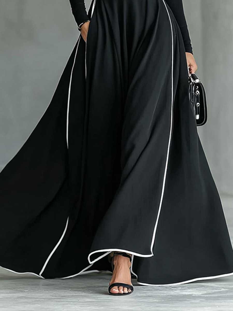 Gina – Vestido largo de mujer negro con costuras blancas, cuello alto, mangas largas y cintura estrecha